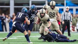 Bryson Daily #13 of the Army Black Knights runs for a short gain in the first quarter against the Navy Midshipmen at Gillette Stadium on December 9, 2023