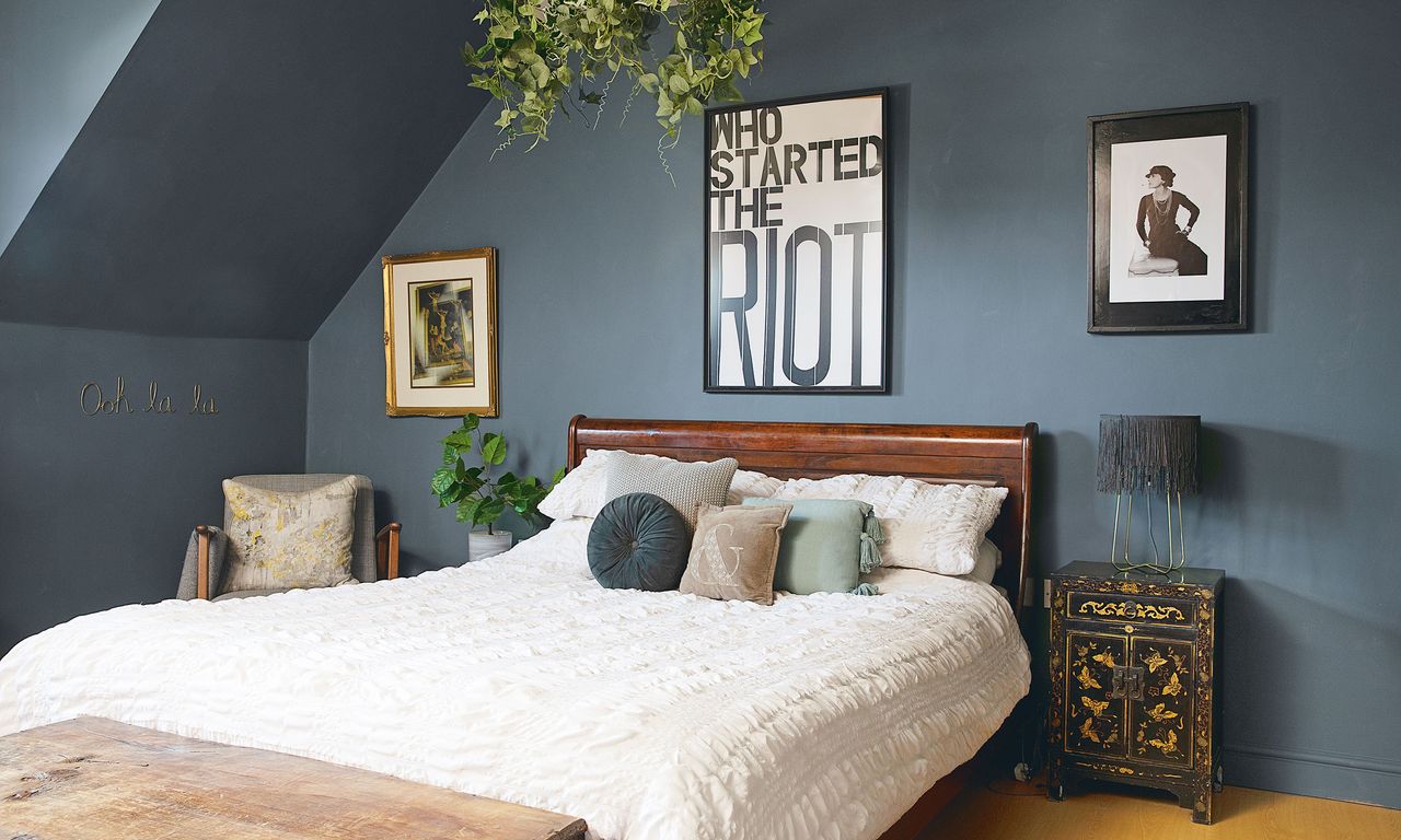 blue master bedroom with wooden bed frame, and white bedroom