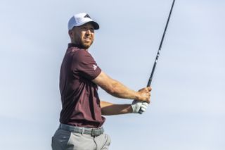 Daniel Berger watches his tee shot with a driver