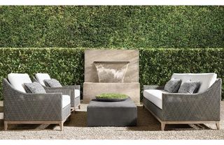 A pair of wicker outdoor sofas facing each other in a courtyard