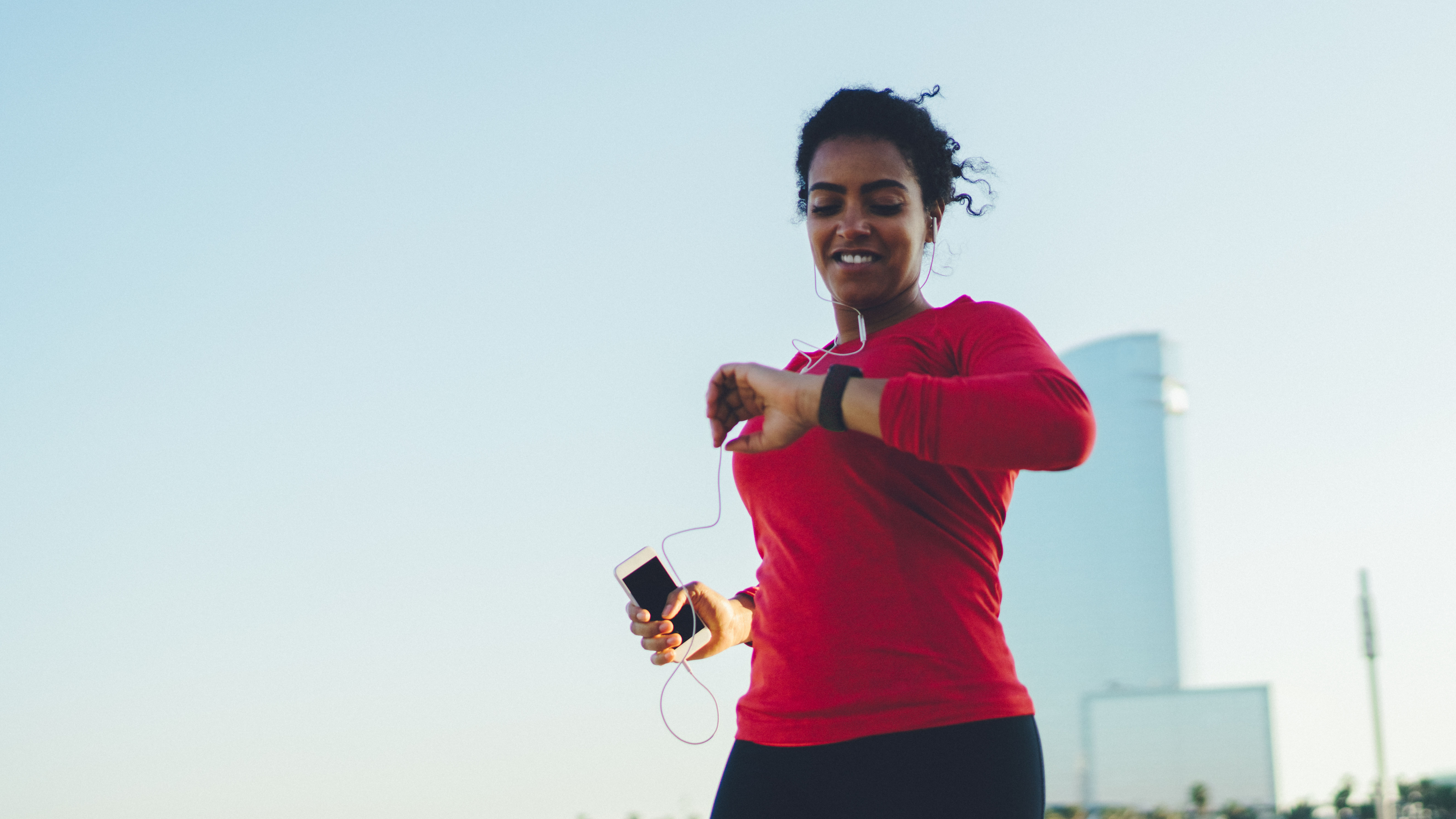 Woman running looking at smartwatch
