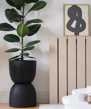 A planter made from Terracotta plant pots with black paint decor