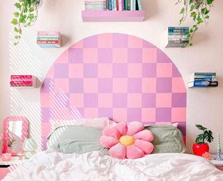 Pink bedroom with pink and purple checkerboard headboard design and kitschy bright pink and green trinkets