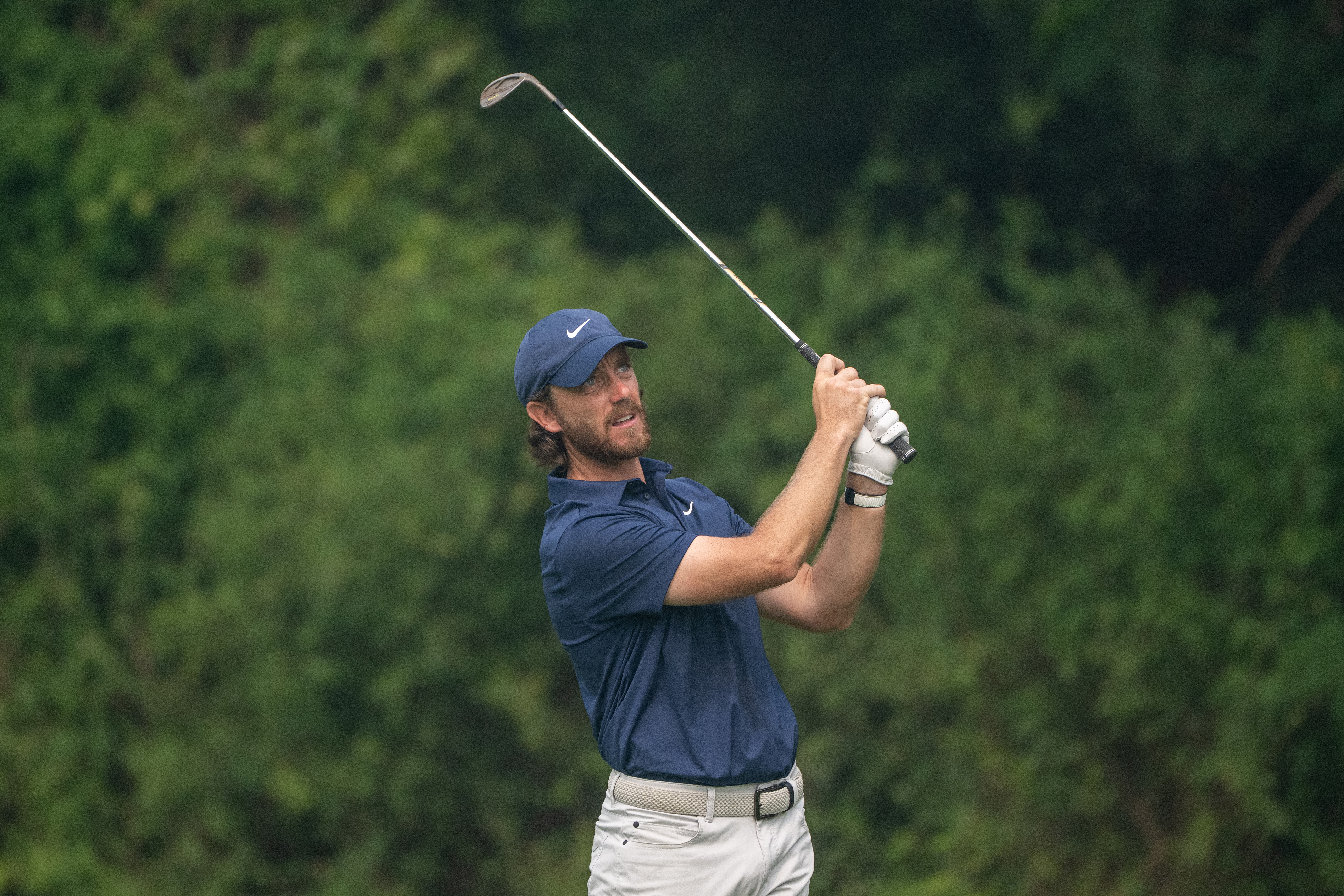 Tommy Fleetwood hits a full shot into the green