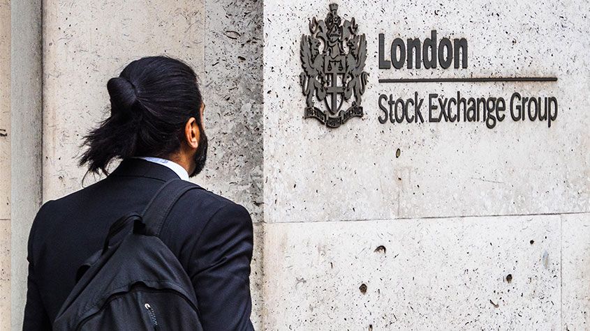 Man walking by the London Stock Exchange