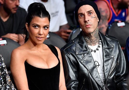 Kourtney Kardashian and Travis Barker are seen in attendance during the UFC 264 event at T-Mobile Arena on July 10, 2021 in Las Vegas, Nevada.