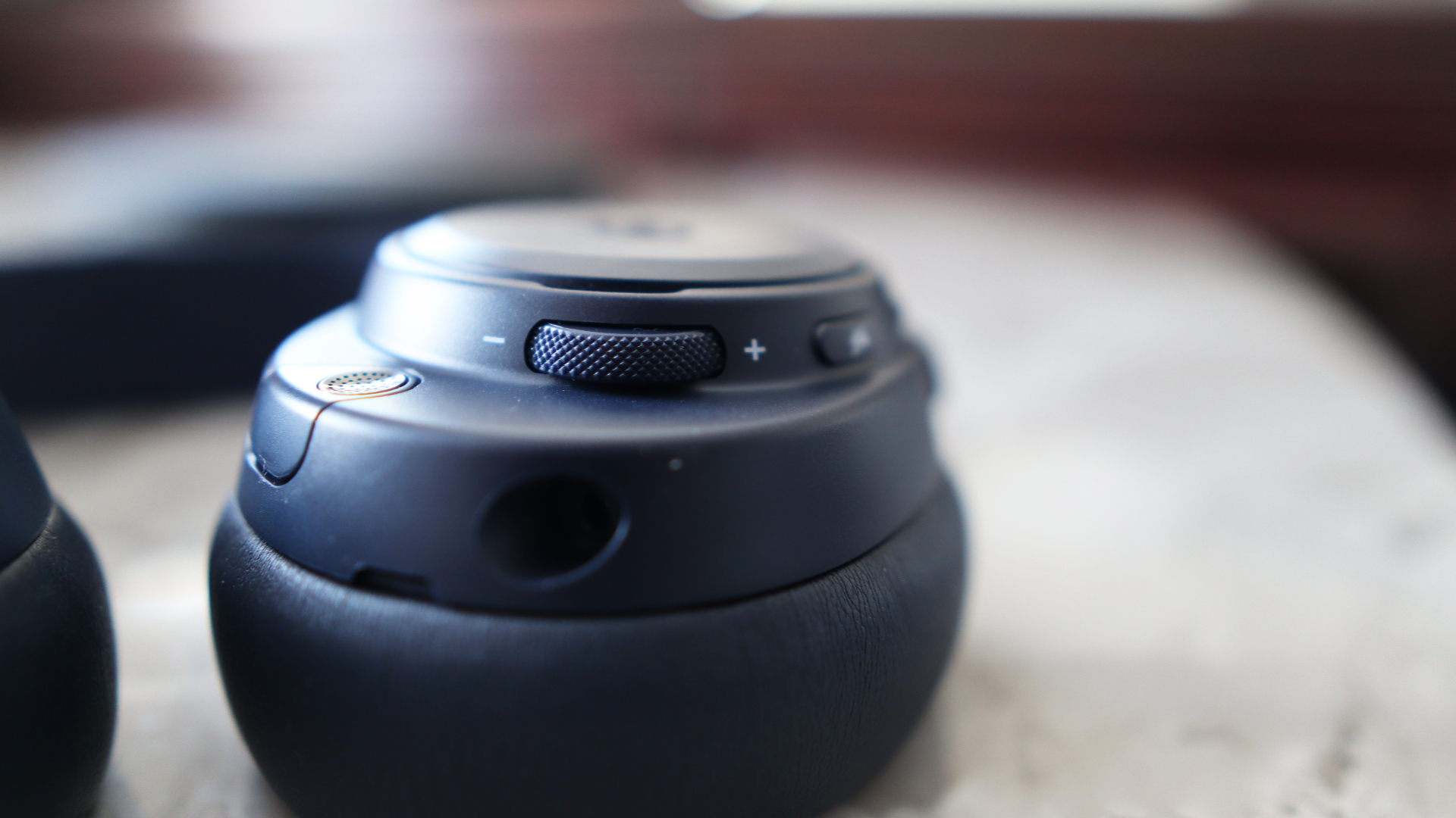 The Arctis Nova Pro Omni from SteelSeries on a desk and chair with accessories.