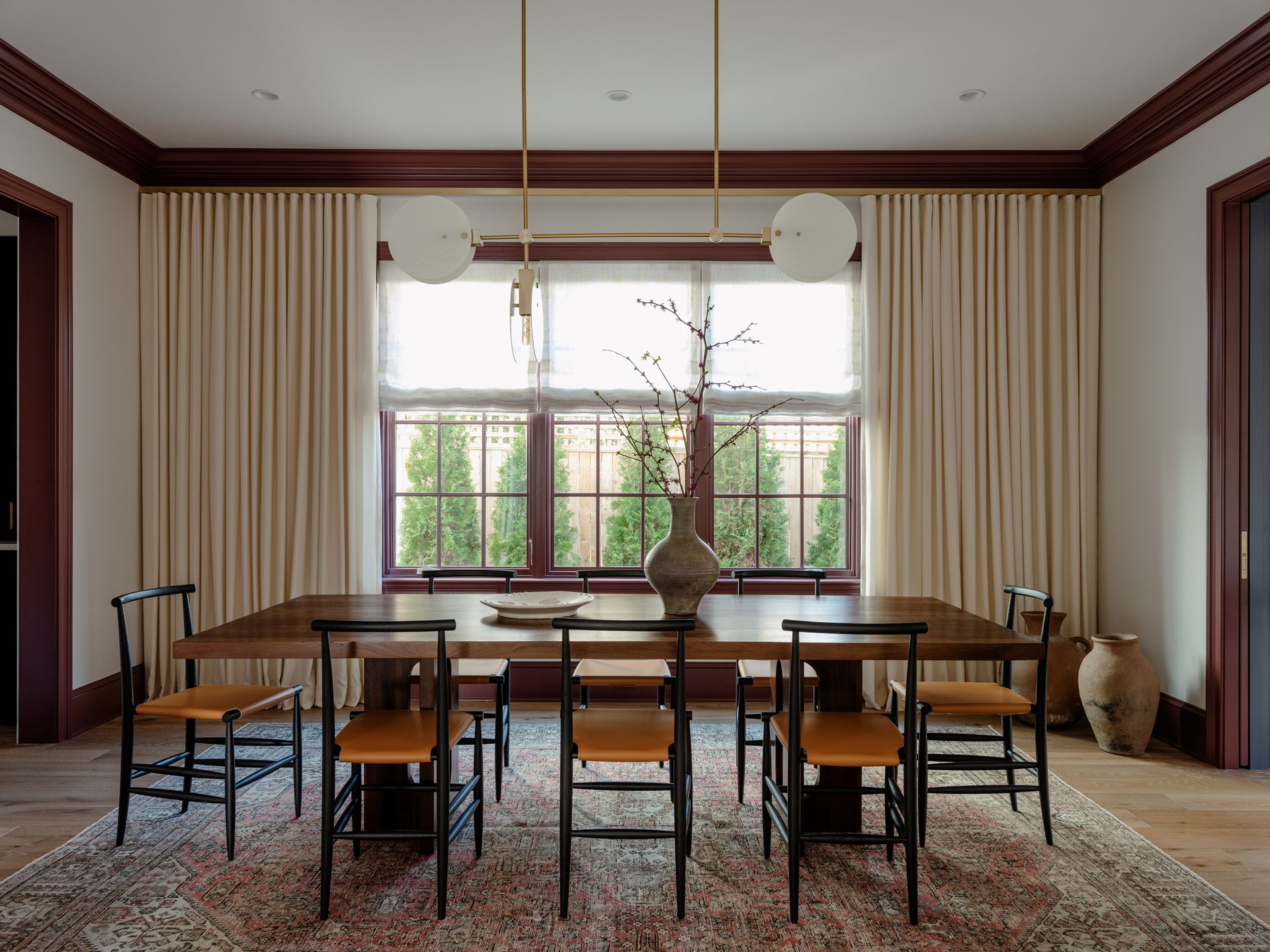 dining room with wood table and chairs, white walls and dark crown moldings and skirtings