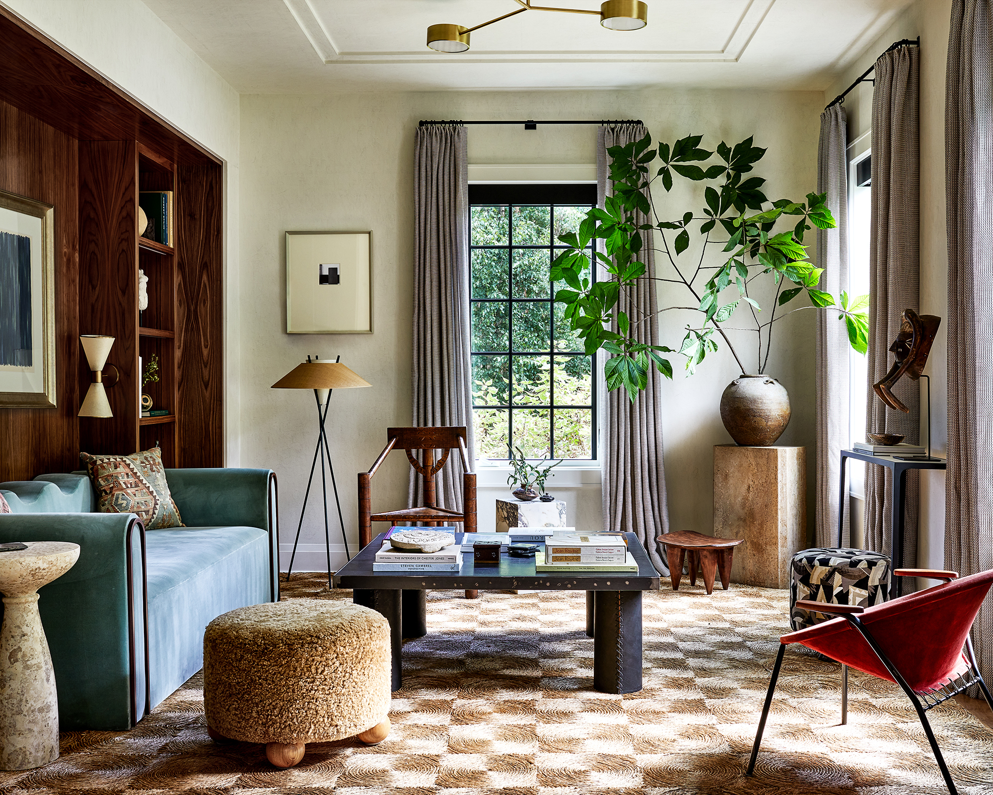 living room with blue sofa and check rug