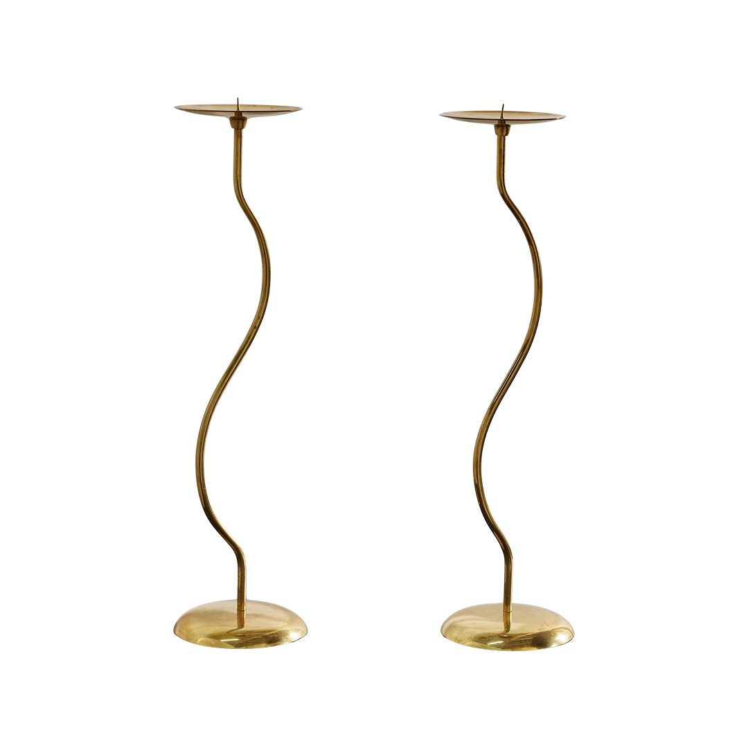 Set of two brass candle sticks with curved design