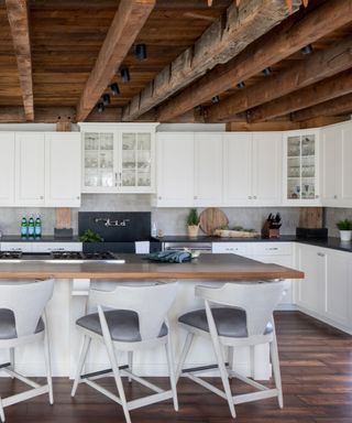 An organic modern kitchen with wooden beams on the ceiling