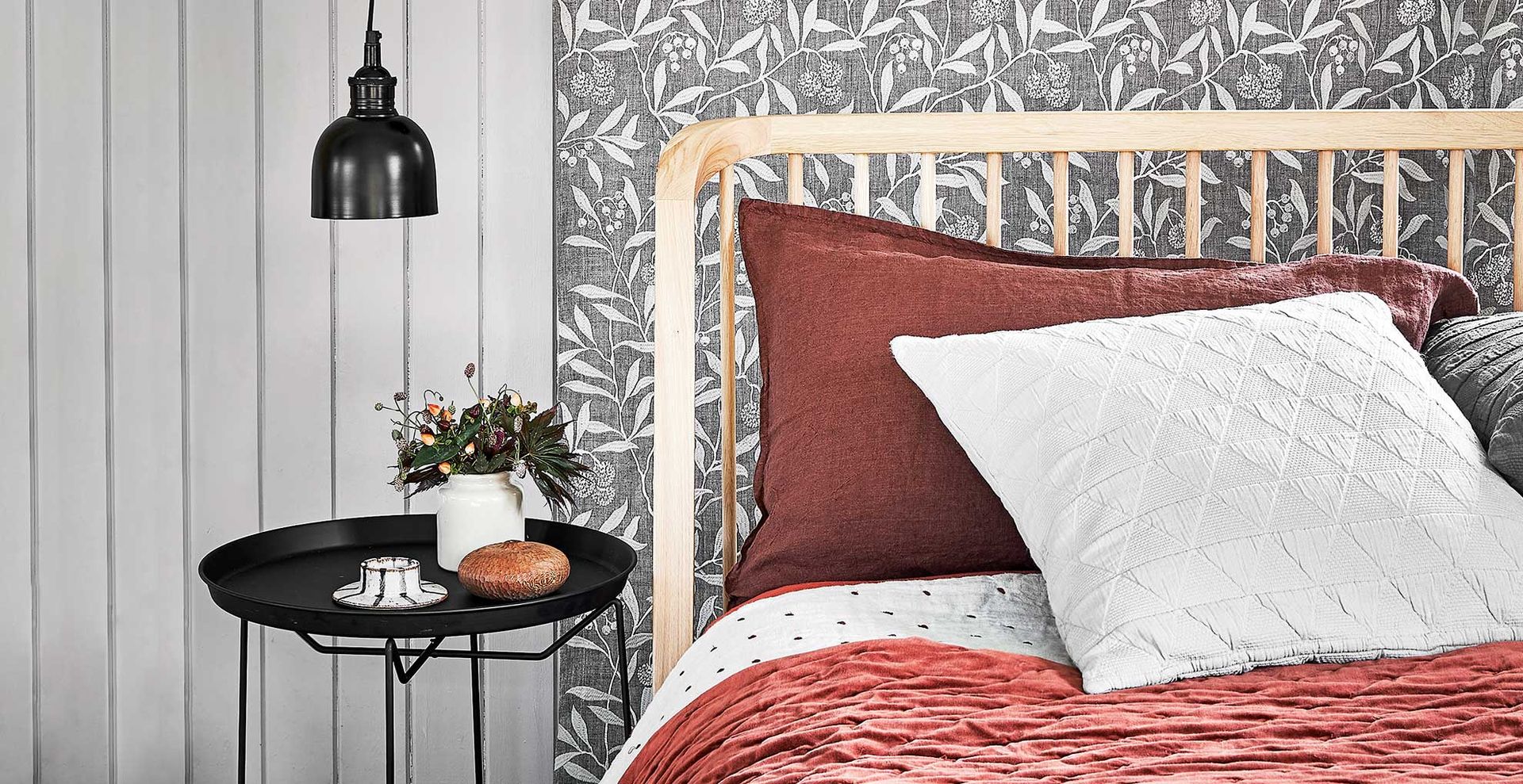 Bedroom with red accent colours and pillows