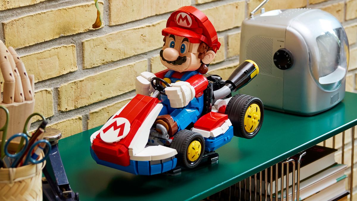 Lego Mario &amp; Standard Kart set on a green shelf in front of an old TV and stationary