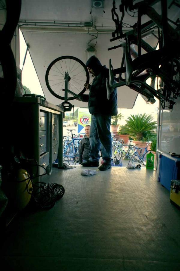 A mechanic works on one of the team's wheels