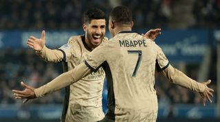 Kylian Mbappe and Marco Asensio celebrate a goal for Paris Saint-Germain against Strasbourg in February 2024.