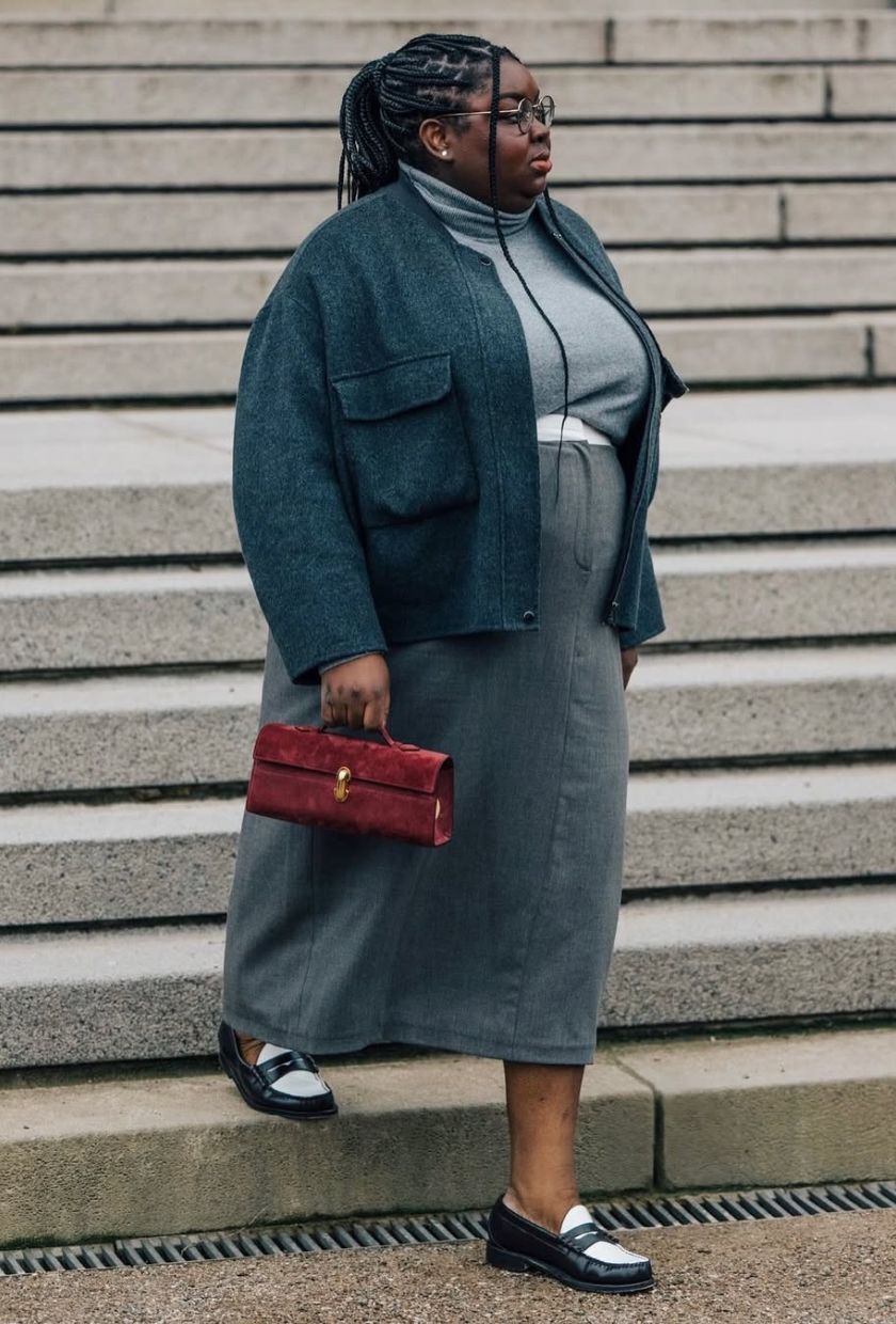 @abimarvel wears. grey wool pencil skirt with a roll-neck knit, wool bomber, black-and-white loafers and a red suede bag