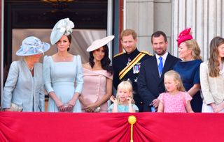 Camilla, Duchess Of Cornwall, Catherine, Duchess of Cambridge, Meghan, Duchess of Sussex, Prince Harry, Duke of Sussex, Peter Phillips, Autumn Phillips, Isla Phillips and Savannah Phillips stand on the balcony of Buckingham Palace during the Trooping the Colour parade