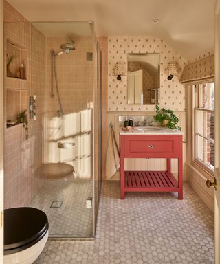 A yellow small bathroom with a walk-in shower with two shower niches for storage