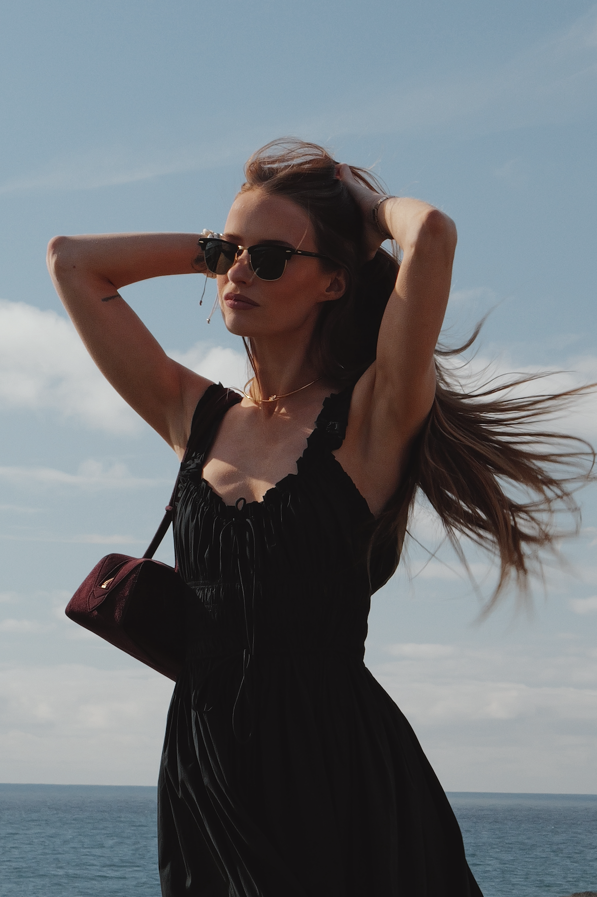 Victoria Magrath wearing a black dress on holiday