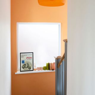 stairway with orange wall and window