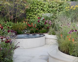 A curved paved area with water feature