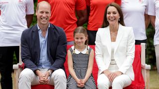 Prince William, Duke of Cambridge, Catherine, Duchess of Cambridge and Princess Charlotte of Cambridge pose for a photograph as they visit SportsAid House