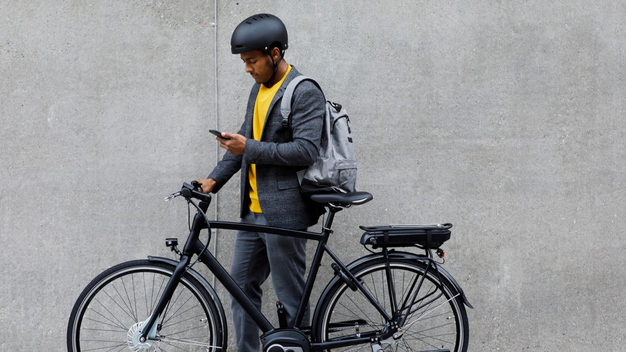 A man with an electric bike on the way to work