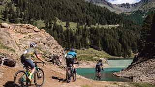 Gravel riders heading toward Pian Palù Lake, Italy