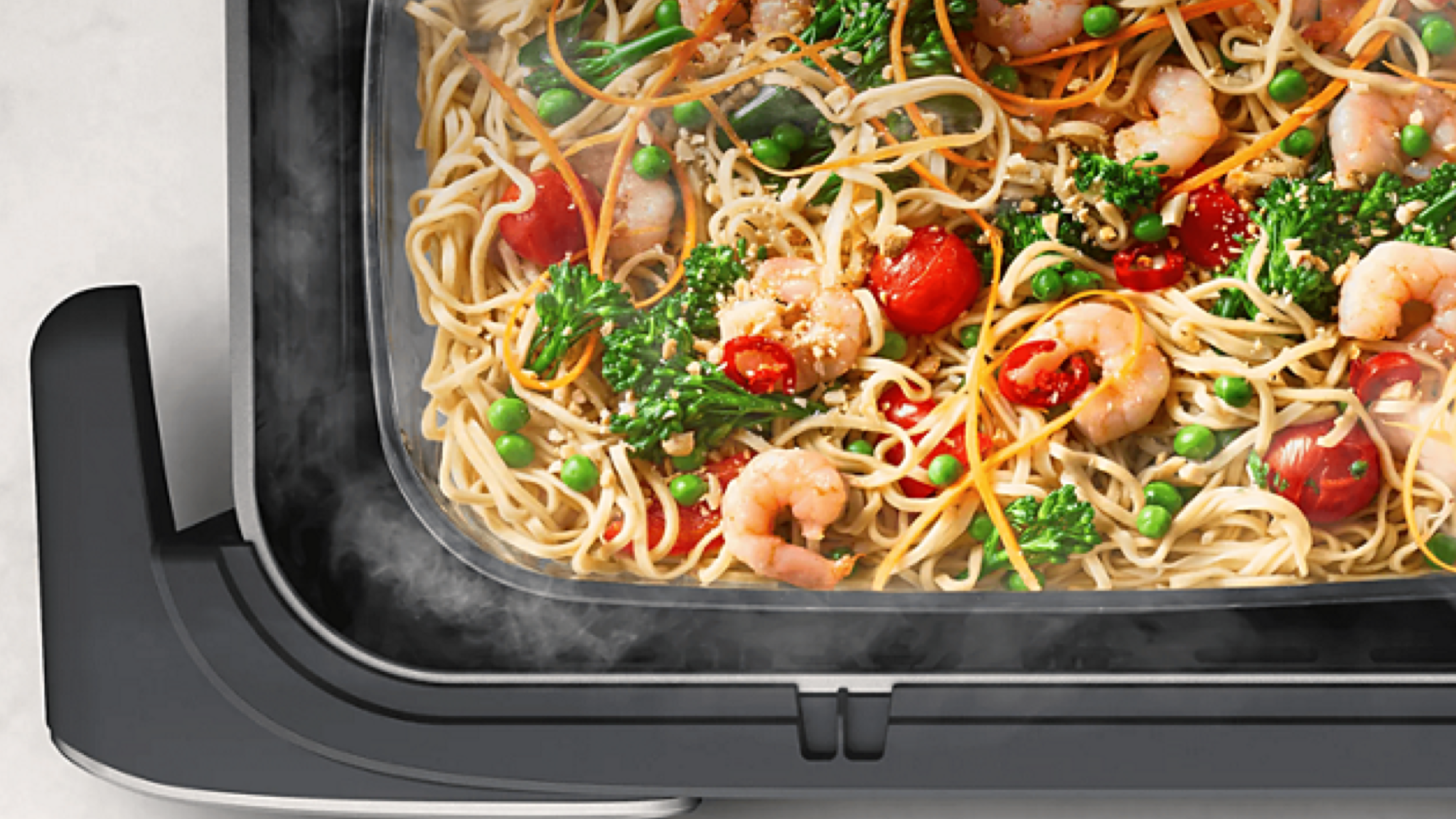 Product photo of the Philips Airfryer 5000 Series Megabasket with Steam shot from above showing food that has been steam cooked