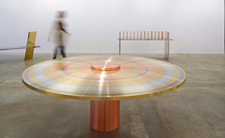 The Freeze Multi Ring Table (pictured here) is comprised of a copper base and then tabletop rings of aluminum, steel, brass and copper