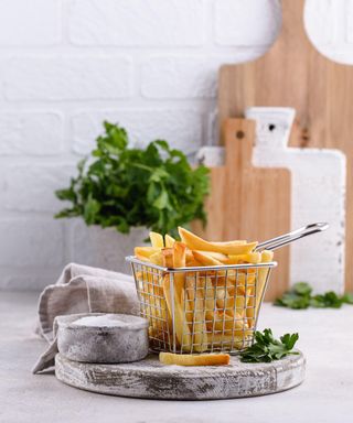 Air fryer in a white tiled kitchen