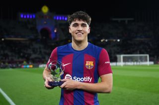 Pau Cubarsi with his Player of the Match award after Barcelona's win over Napoli in the Champions League in March 2024.