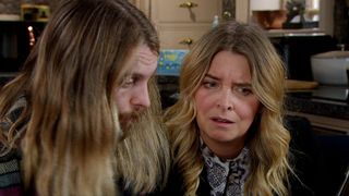 Charity is shocked as she and Ryan look through a laptop she's stolen from Home Farm