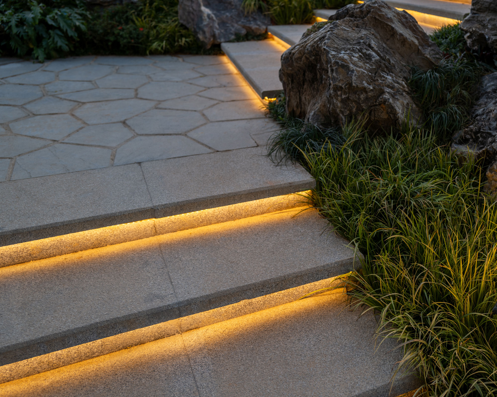 garden steps with lighting, rocks and ornamental grasses