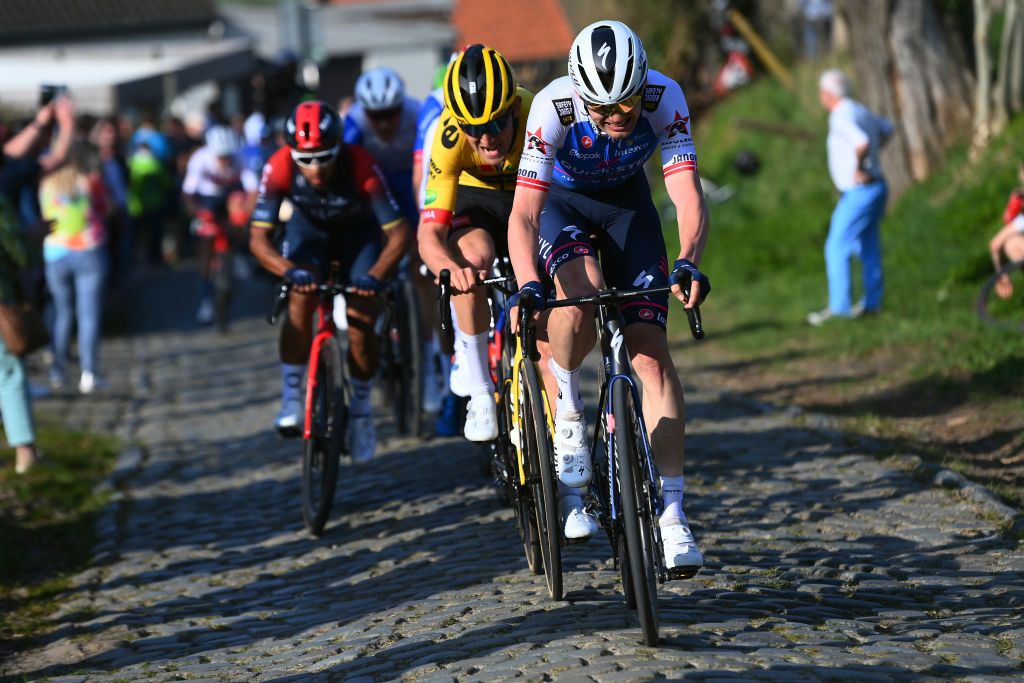 HARELBEKE BELGIUM MARCH 25 LR Tiesj Benoot of Belgium and Team Jumbo Visma and Kasper Asgreen of Denmark and Team QuickStep Alpha Vinyl through Kwaremont cobblestones sector during the 65th E3 Saxo Bank Classic 2022 a 2039km one day race from Harelbeke to Harelbeke E3SaxobankClassic WorldTour on March 25 2022 in Harelbeke Belgium Photo by Tim de WaeleGetty Images