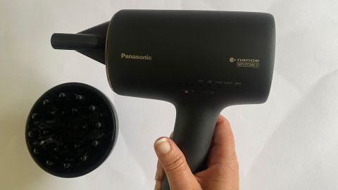 A hand holding the Panasonic Nanoe Moisture+ and Mineral hair dryer
