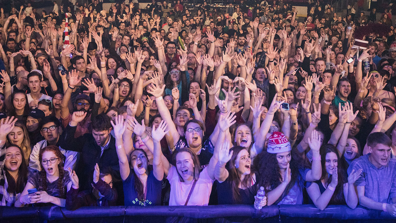 A photograph of a big crowd of young people at a gig