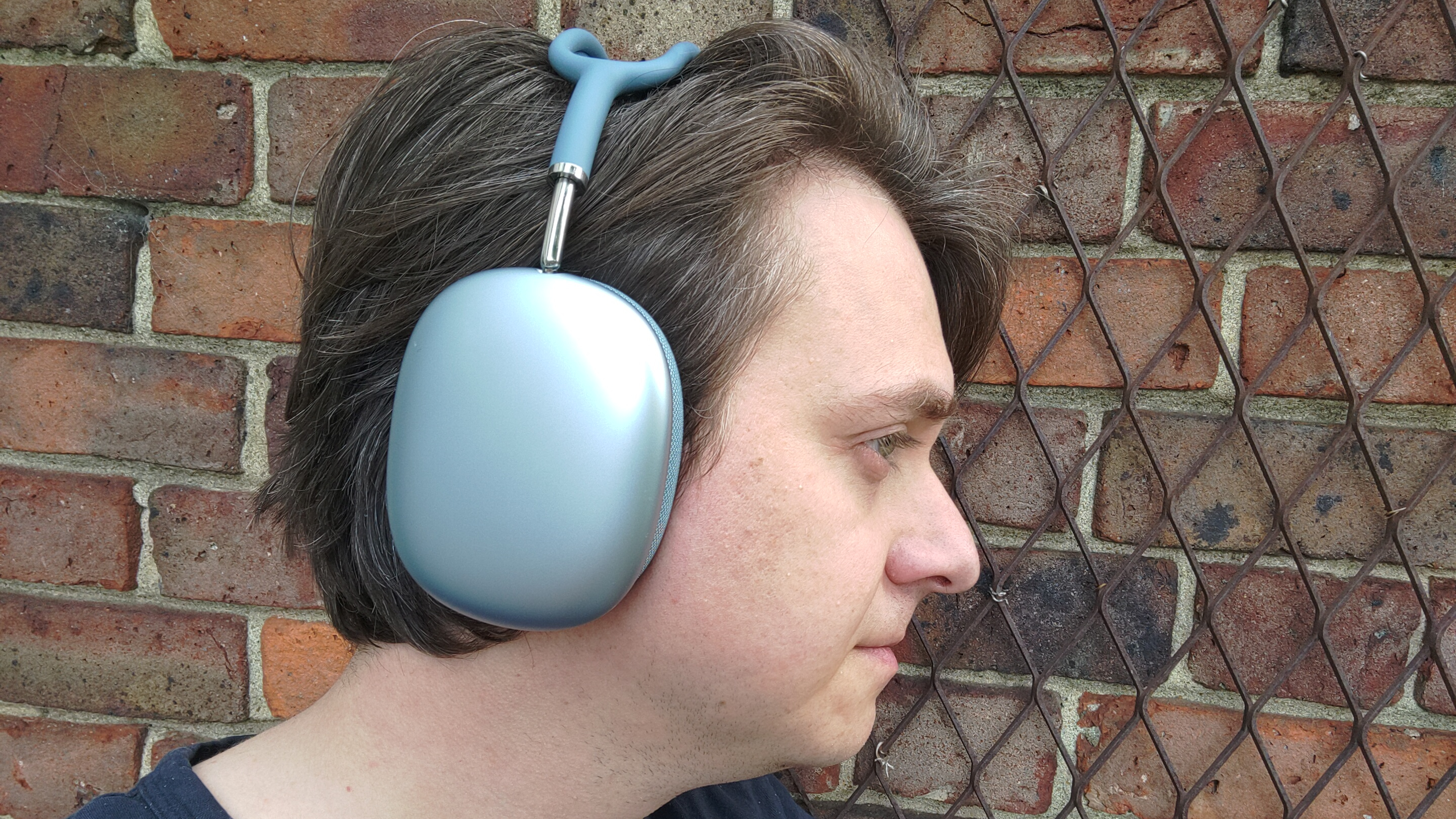Photograph of man wearing Apple AirPods Max 2 headphones