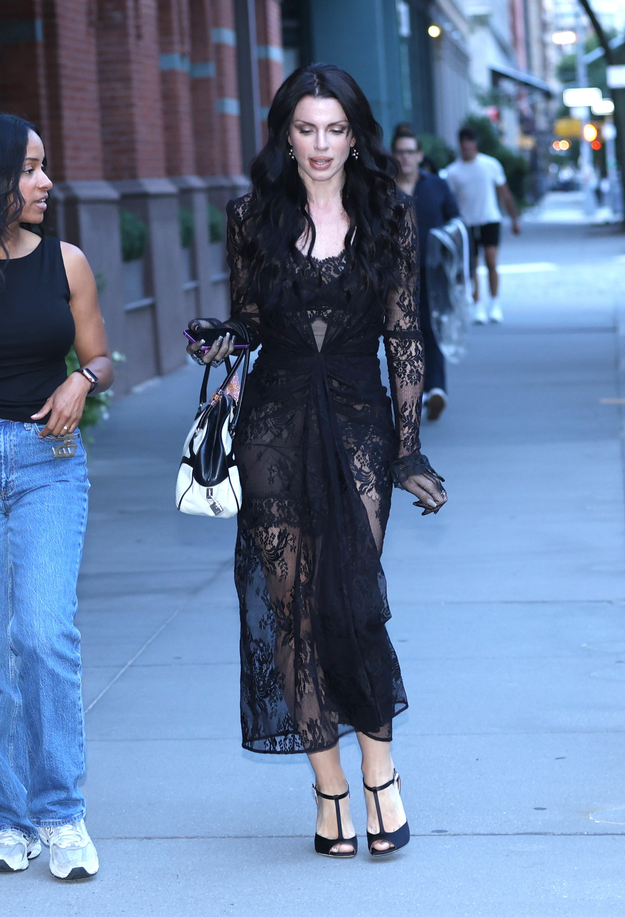 julia fox wearing a black lace dress and stilettos