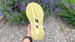 Person holding the Hoka Skyward X showing the outsole of the shoe