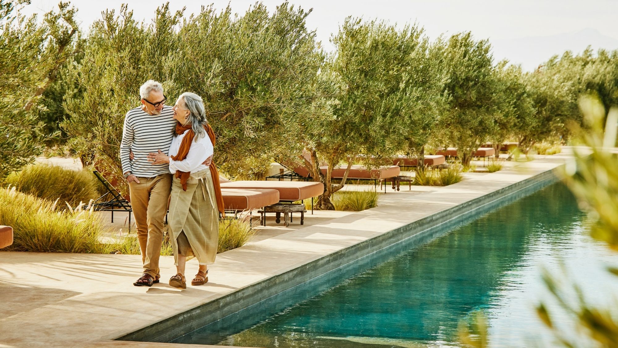 senior couple walking poolside