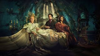 Great Expectations cast: Olivia Colman in a flowing white dress and head-dress as Miss Havisham sits beside Fionn Whitehead in a dark suit and red tie as Pip and Shalom Brune-Franklin in a red dress as Estella in Great Expectations