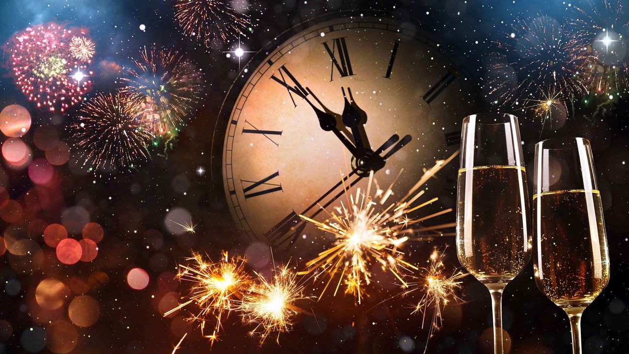 Concept art of New Year&amp;#039;s Eve with a clock about to strike 12, fireworks and champagne