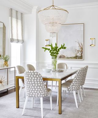 Grey and white spotted chairs, white table top and gold table legs