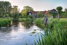 River Test looking back towards the mill with figurative sculpture. ©Andrea Jones / Garden Exposures