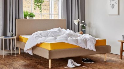 Eve the warm:cool duvet on yellow mattress in bright bedroom with shoes on the floor