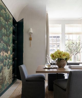 dining room with green patterned wallpaper on built in storage
