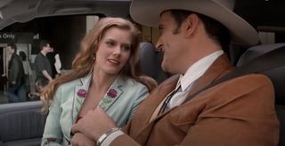Amy Adams shares a happy moment with Bruce Campbell in a car in Serving Sara,
