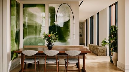 Studio Ashby interior with dining room table with green resin pictures on the wall