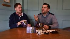two golfers going over their scorecards in the clubhouse after a round of golf